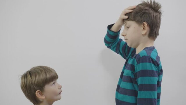 Brothers measuring and comparing their heights