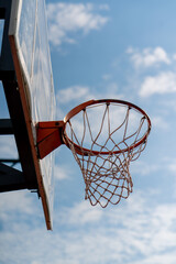 A close-up of a basketball hoop into which a basketball hits the concept of admiration for the game of basketball and love of working out  © Guys Who Shoot