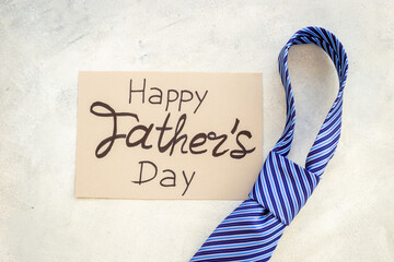 Happy Fathers day postcard with blue tie, top view
