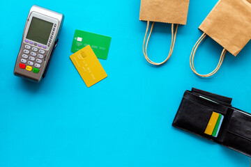 Fototapeta premium Retail and shopping concept. Pos payment terminal with credit cards and shopping bags