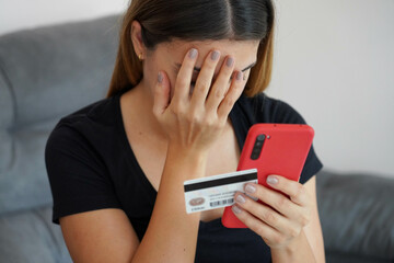 Digital theft. Desperate young woman finds out that her credit card was cloned and her bank account emptied. Cyber security concept.