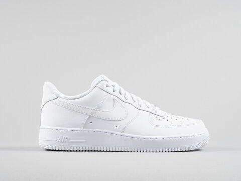 Copenhagen, Denmark - May 4, 2019: Nike Air Force 1 '07 white sneakers product shot isolated on light grey background. Illustrative editorial photo.