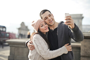 young couple takes a selfie in the city