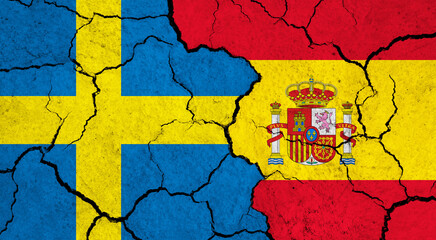 Flags of Sweden and Spain on cracked surface - politics, relationship concept