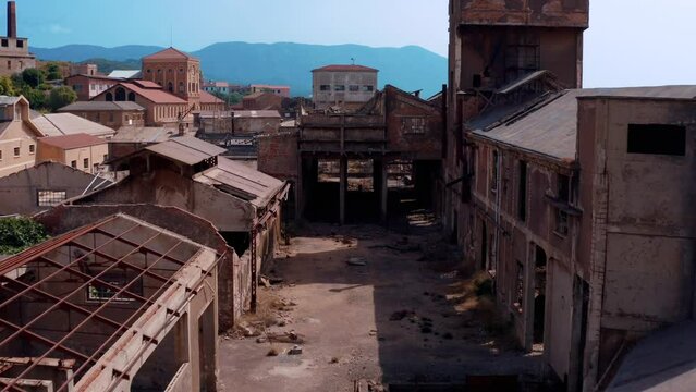 Flying with a drone inside an old factory in ruin - Sardinia