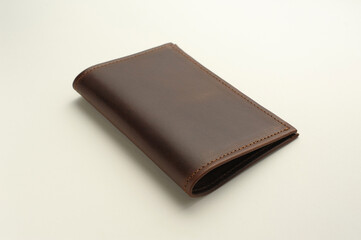 front side of a leather brown male cover for documents on a white background