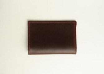 back side of a leather brown male cover for documents on a white background
