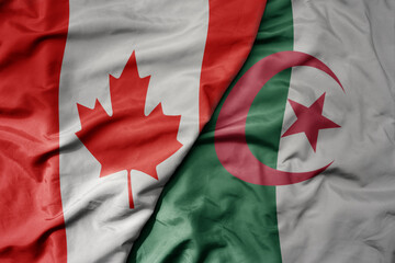 big waving realistic national colorful flag of canada and national flag of algeria .