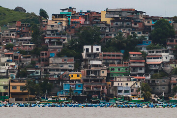Mussel and seafood farm with floating buoys in Jurujuba bay below hillside favela community in Niteroi, Rio de Janeiro, Brazil © Iury