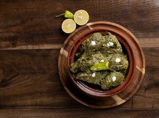 Palak paneer, spinach curry with chicken on a table
