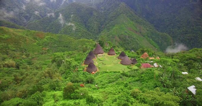 Aerial drone of beautiful village in tropical valley between the hill. Traditional village Waerebo Indonesia