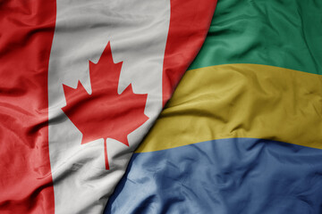 big waving realistic national colorful flag of canada and national flag of gabon .