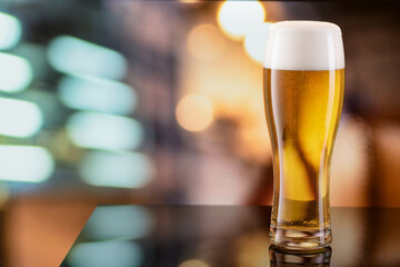 Weizen glass of beer on top of bar counter. Copy space.