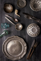 Various antique vintage dishes on black background