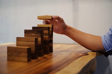 Planning risk and strategy in businessman gambling placing wooden block.Business concept for growth success process