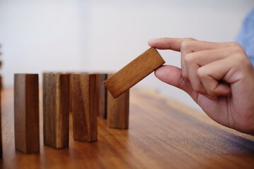 Planning risk and strategy in businessman gambling placing wooden block.Business concept for growth success process