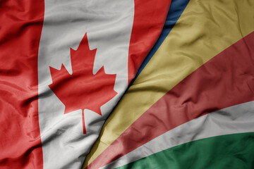 big waving realistic national colorful flag of canada and national flag of seychelles .