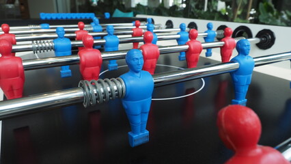 Football table or soccer table game with plastic player figurine. Mini Soccer game which famous in past and be collectable item for foosball lover. Play by two hand control each row of player figurine - obrazy, fototapety, plakaty
