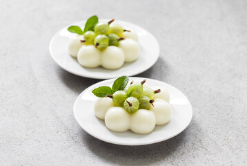 Vegan dessert. Gooseberry cream cake, Panna Cotta in the shape of truffles, decorated with fresh...