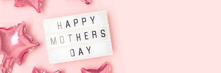 Happy Mothers Day - quote. Banner with star shape foil balloons and lightbox on a pink pastel background.