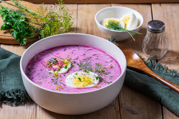 Traditional summer cold beetroot soup with cucumber, egg and sour cream on a wooden background. Rustic style. - 629589507