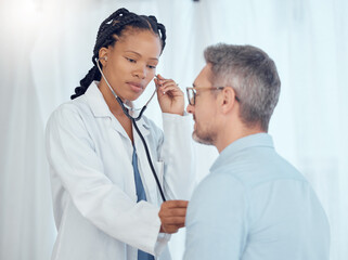 Doctor, black woman listening with stethoscope to patient heartbeat, healthcare services and...