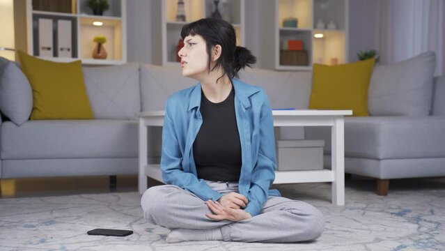 The young woman who smells bad odor is disturbed and disgusted.