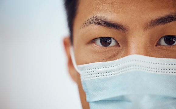 Doctor, portrait and Asian man with mask, mockup banner and safety in healthcare in hospital on white background. Ppe, face and eyes of medical professional, rules and compliance work in clinic space