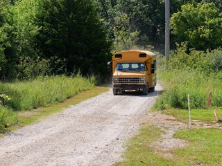Old school bus on rural gravel road