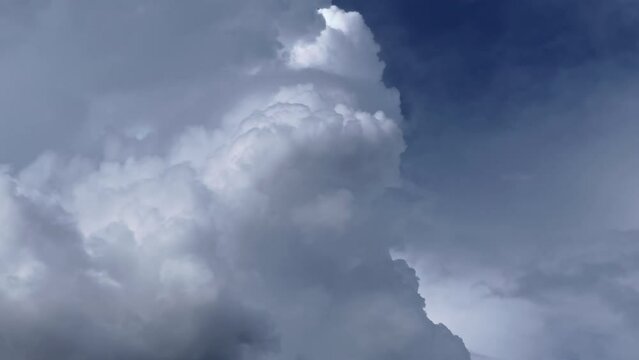 Closeup footage of huge cumulonimbus cloud swelling and rising up. Cloudscape, Japan