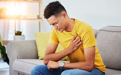 Man, sofa and chest pain in home, massage and relief from stress or injury in living room. Health,...