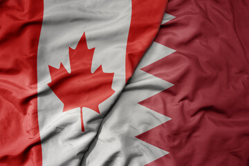big waving realistic national colorful flag of canada and national flag of bahrain