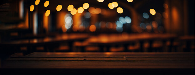 Wooden table and blur beach cafes background with bokeh lights.