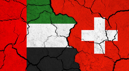 Flags of United Arab Emirates and Switzerland on cracked surface - politics, relationship concept