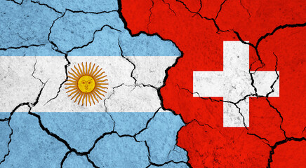Flags of Argentina and Switzerland on cracked surface - politics, relationship concept
