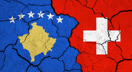 Flags of Kosovo and Switzerland on cracked surface - politics, relationship concept
