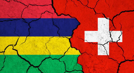Flags of Mauritius and Switzerland on cracked surface - politics, relationship concept