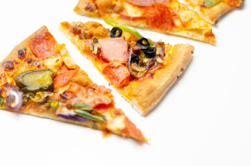 Different slices of pizza with pepperoni, ham, mushrooms, mozzarella and olives