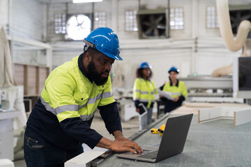 Male engineer worker working with computer in industry factory. Male technician using laptop computer control and maintaining machine in the factory - Powered by Adobe