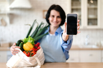 Selective focus on woman hand holding smartphone with empty screen