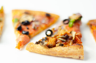Different slices of pizza with pepperoni, ham, mushrooms, mozzarella and olives