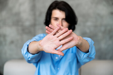 Selective focus on woman hands showing stop gesture