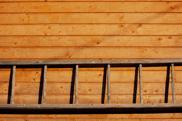 Wooden staircase hanging on wooden wall, background, copy space, rural scene. High quality photo