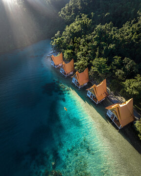 Aerial view of luxury resort overwater bungalow along the coast of Bucas Grande Island, Surigao del Norte, Philippines.