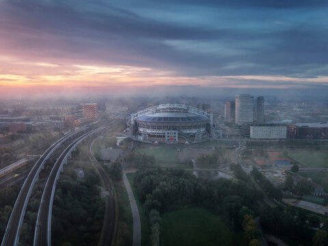 Amsterdam, Netherlands - 04 October 2022: Aerial view of the Johan Cruijff Arena, a stadium at sunset with fog in Amsterdam, the Netherlands.