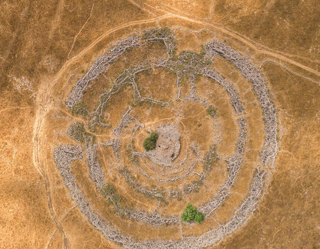 Aerial view of ancient megalithic monument site in the shape of 3 concentric stone circles, Rujum Al-Hiri, Golan Heights, Israel.