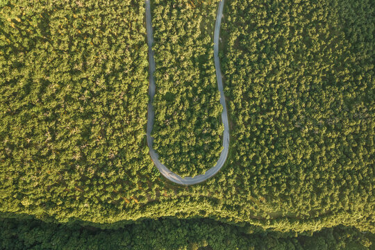 Aerial view of a u turn road climbing the Mount Terminio at sunset, Serino, Campania, Avellino, Italy.