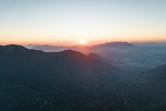 Aerial view of the sun setting down across the valley in Serino along the Mount Terminio with National park, Campania, Avellino, Italy.