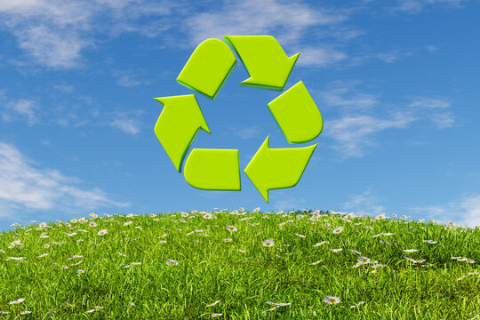 Recycling icon over grassy blooming meadow meadow in sunlight