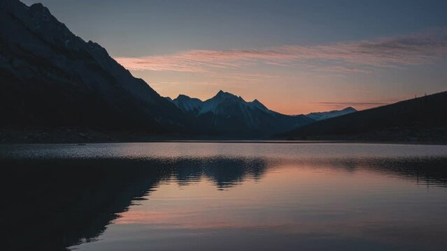 Sunrise over Medicine lake with rocky mountains and lake reflection in the morning at Jasper national park